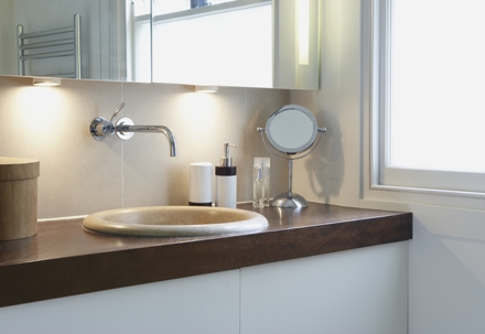 Bathroom vanity beside window.